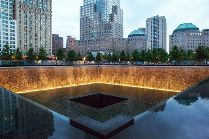 Experience the poignant serenity of the 9/11 Memorial where reflective pools honor the past offering a profound connection to history amidst the modern skyline of New York City.
